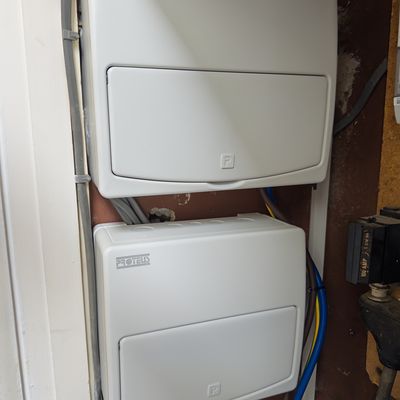 Two new domestic consumer units installed in a cupboard