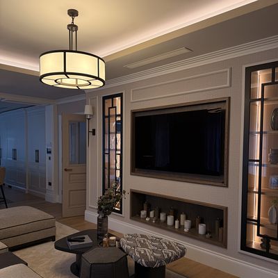 Living room with pendant light, cove lighting and illuminated display cabinets